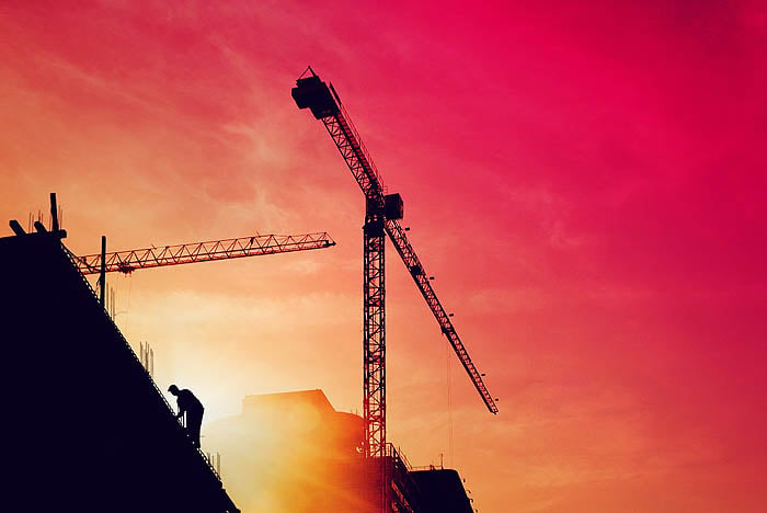 Construction worker on a building in sunset